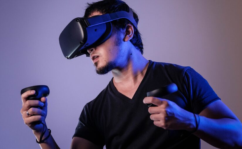 Man wearing a VR headset and holding controllers in their hands